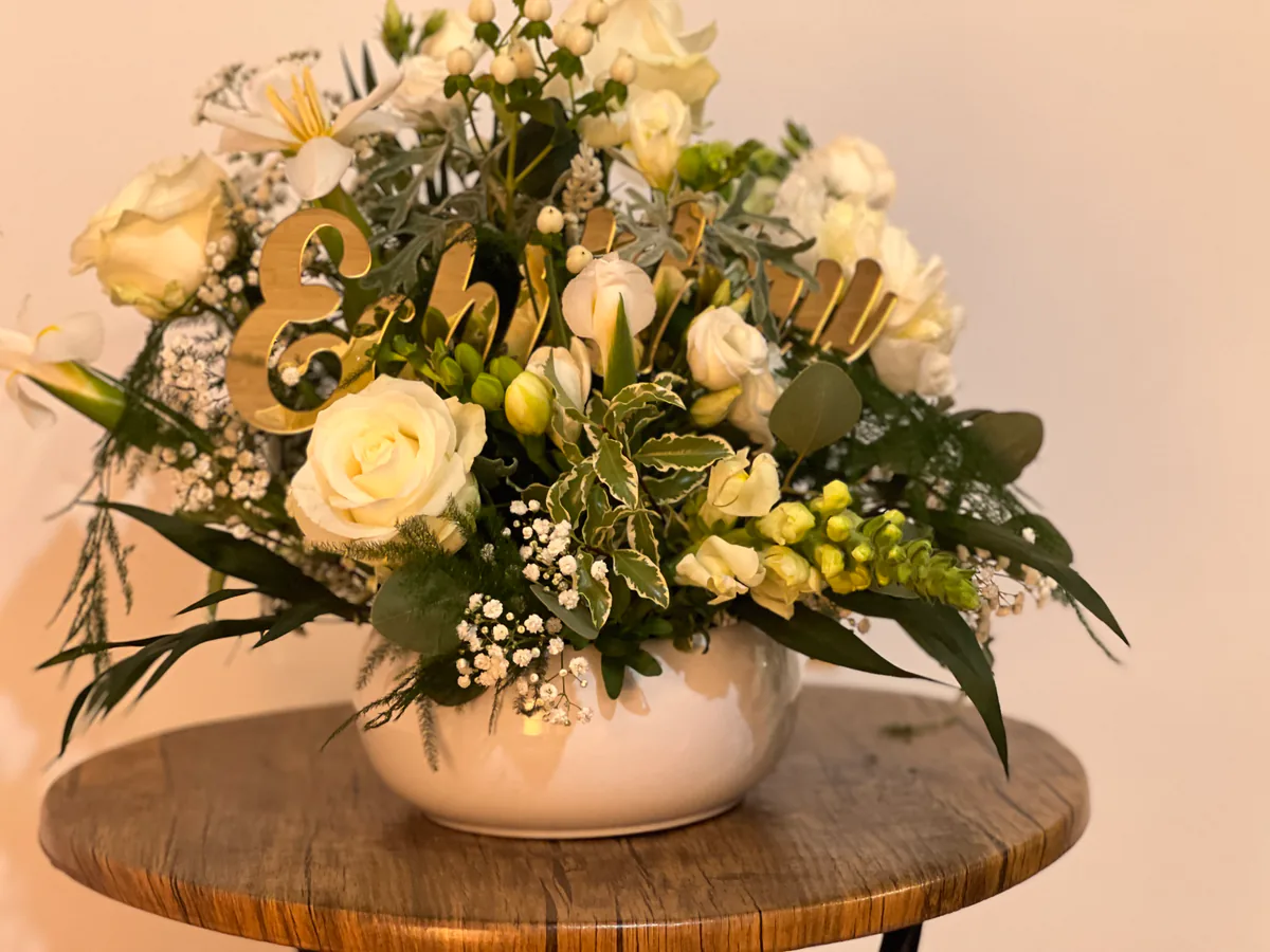 Aranjament floral alb personalizat, cu mesaj din litere aurii printre trandafiri